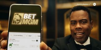 Chris Rock returns for latest BetMGM UK ad campaign Chris Rock holds up a phone with the BetMGM logo on