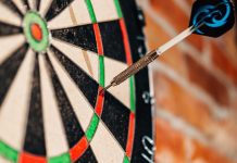 Former darts prodigy Bennett among duo banned by DRA Close up of a dart on a dart board