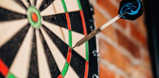 Former darts prodigy Bennett among duo banned by DRA Close up of a dart on a dart board