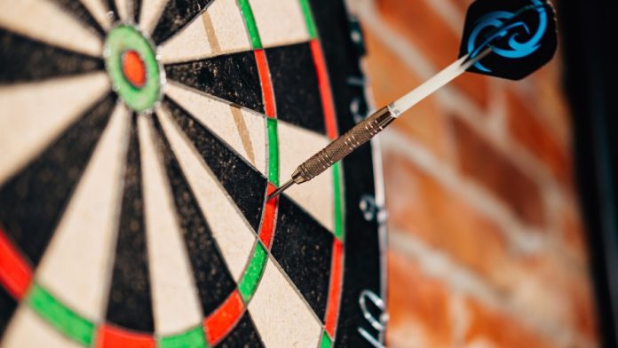 Close up of a dart on a dart board