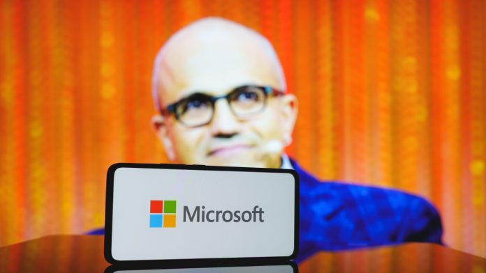 Microsoft logo and CEO Satya Nadella in the background