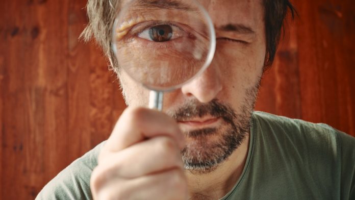 Man looking through microscope