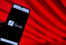 Grok 3 surpasses ChatGPT in Apple charts after standalone app launch Grok logo on a phone screen in front of a red background